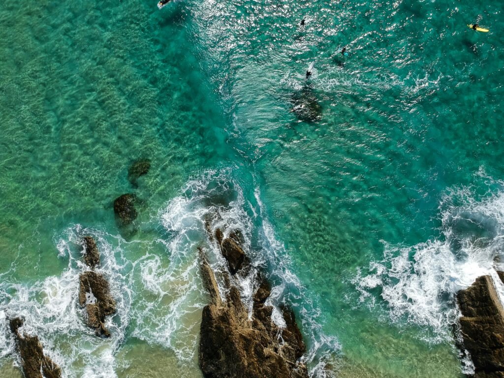 pexels-photo-1310035-1310035 A stunning aerial view of Currumbin Beach, capturing waves and vibrant ocean hues.