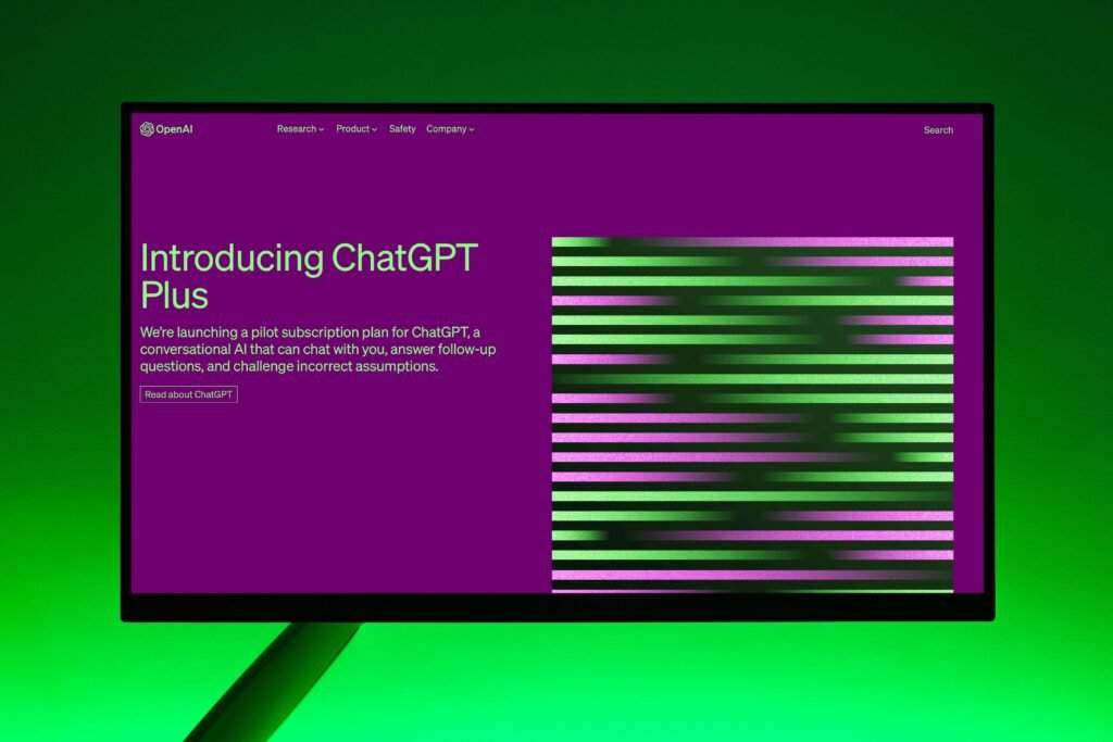 Close-up of a monitor displaying ChatGPT Plus introduction on a green background.