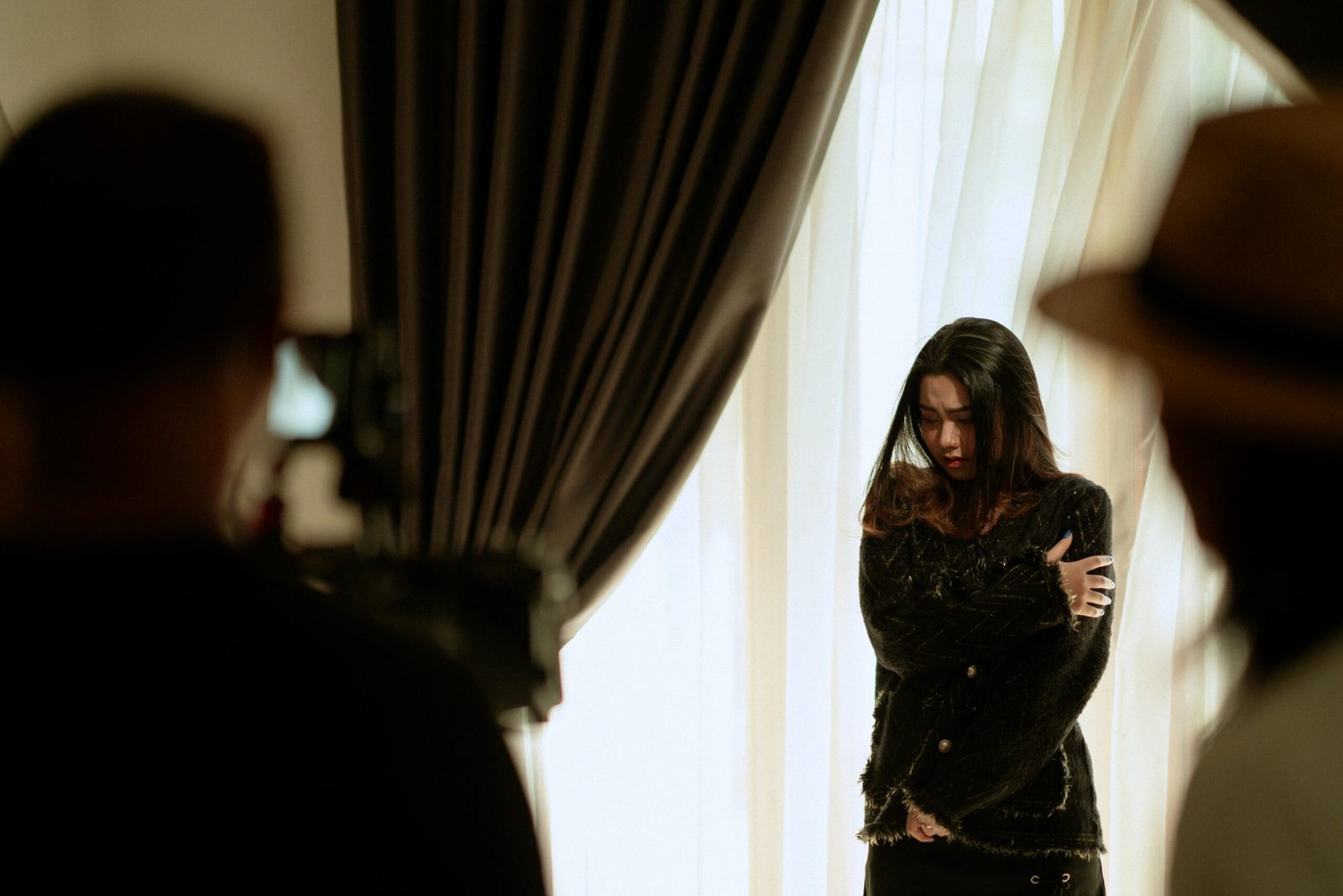 A woman actor performing a scene indoors, captured with dramatic lighting and intense emotion.