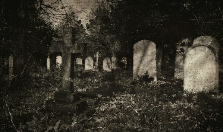 Eerie vintage-style photograph of an old cemetery with gravestones and cross under shadows.