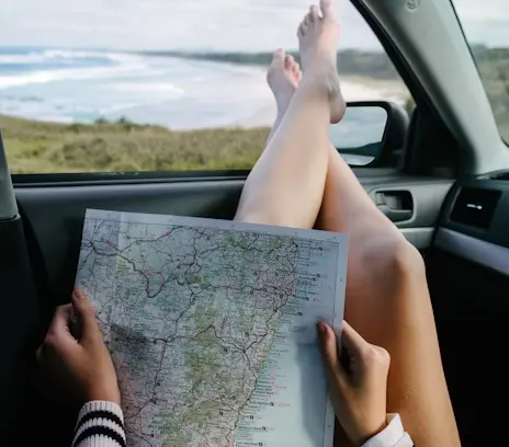 A traveler looking at a map or using a smartphone for navigation in a bustling street market in a budget-friendly city