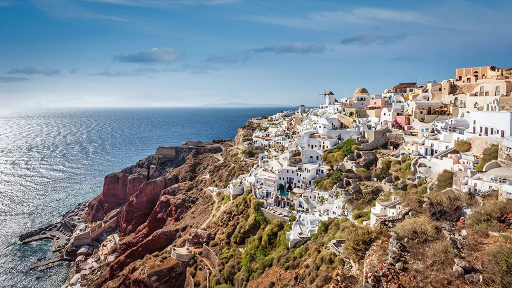 oia-greece-sunset-view-drone-view 8. Whitewashed houses of Oia, Greece, overlooking the Aegean Sea.