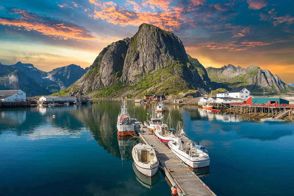 reine-norway-fishing-village-port 7. Fishing village of Reine in Norway with fjord backdrop.